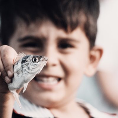 Boy with fish; innocent enthusiasm